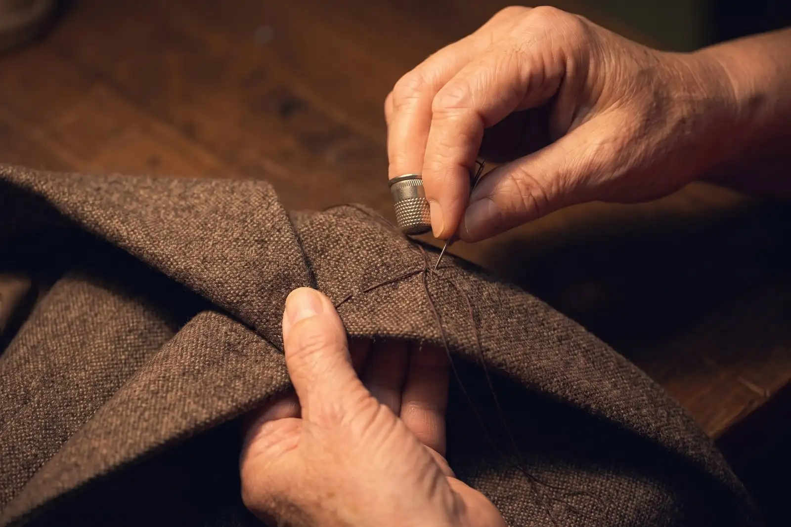 A tailor sewing by hand