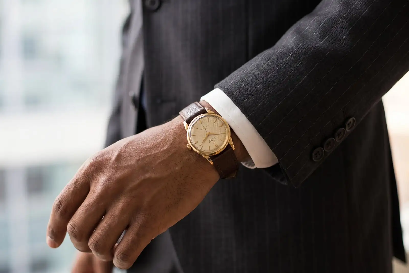 A watch against a suit cuff